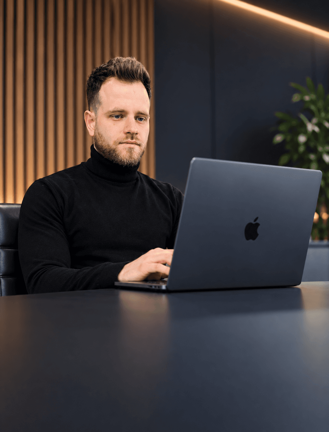 Paul, software developer, working on custom software at a desk in Warsaw